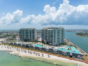 A coastal hotel with multiple high-rise buildings, a beachfront, and a swimming pool area. - Kanaa Marina - Luxury Oceanview Residence (Progreso)