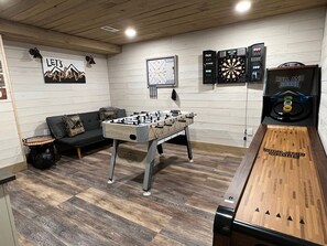 A room with a foosball table, a dartboard, and a foosball table with a scoreboard. - Heavenly Honey Bear | Helen Getaway w/ Fire Pit (Helen)