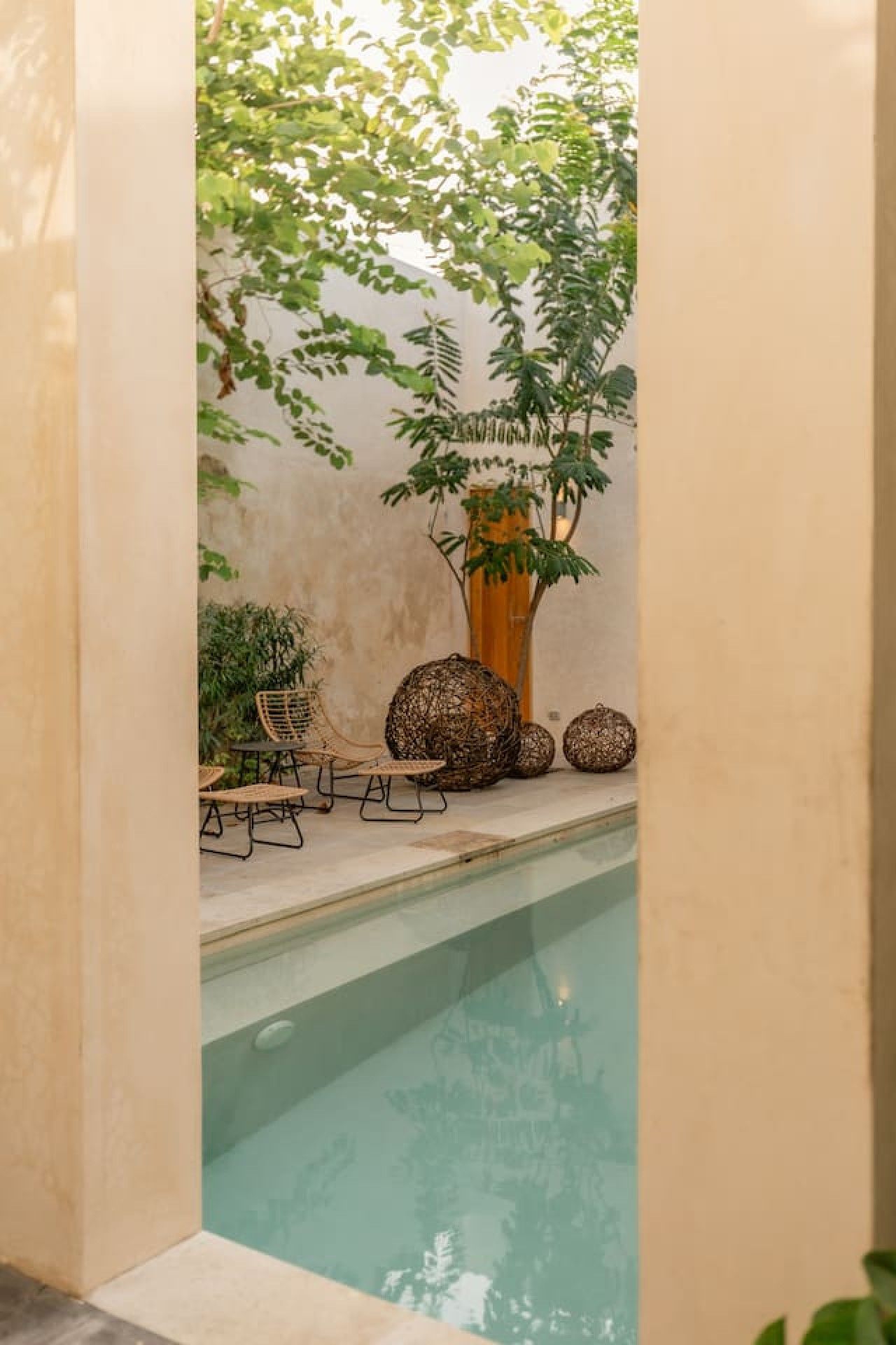A pool area with a seating arrangement and decorative elements.