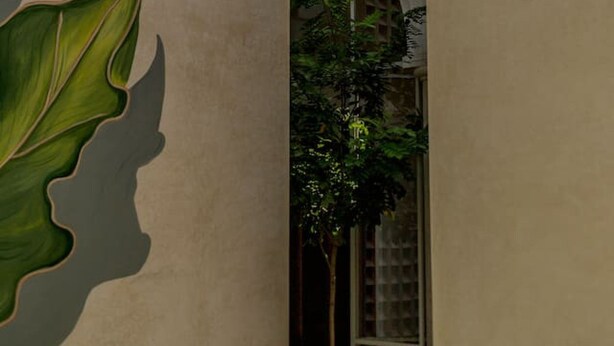 A building with a large green leaf mural, a window, and a door. - Lepan · 1 rec · 1 baño · Balcón privado en Centro (Mérida)