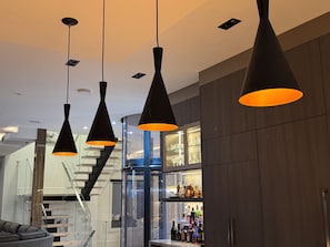 A modern interior with pendant lighting, a staircase, and a bar area. - Modern Waterfront Oasis. Sunsets • Serenity • Dock (Brechin)