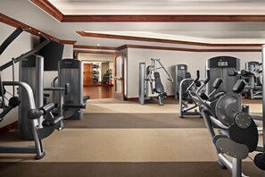A gym with various exercise machines, a mirror, and a wooden ceiling. - The Ritz-Carlton Club Vail 3 Bedroom Residence (Vail)