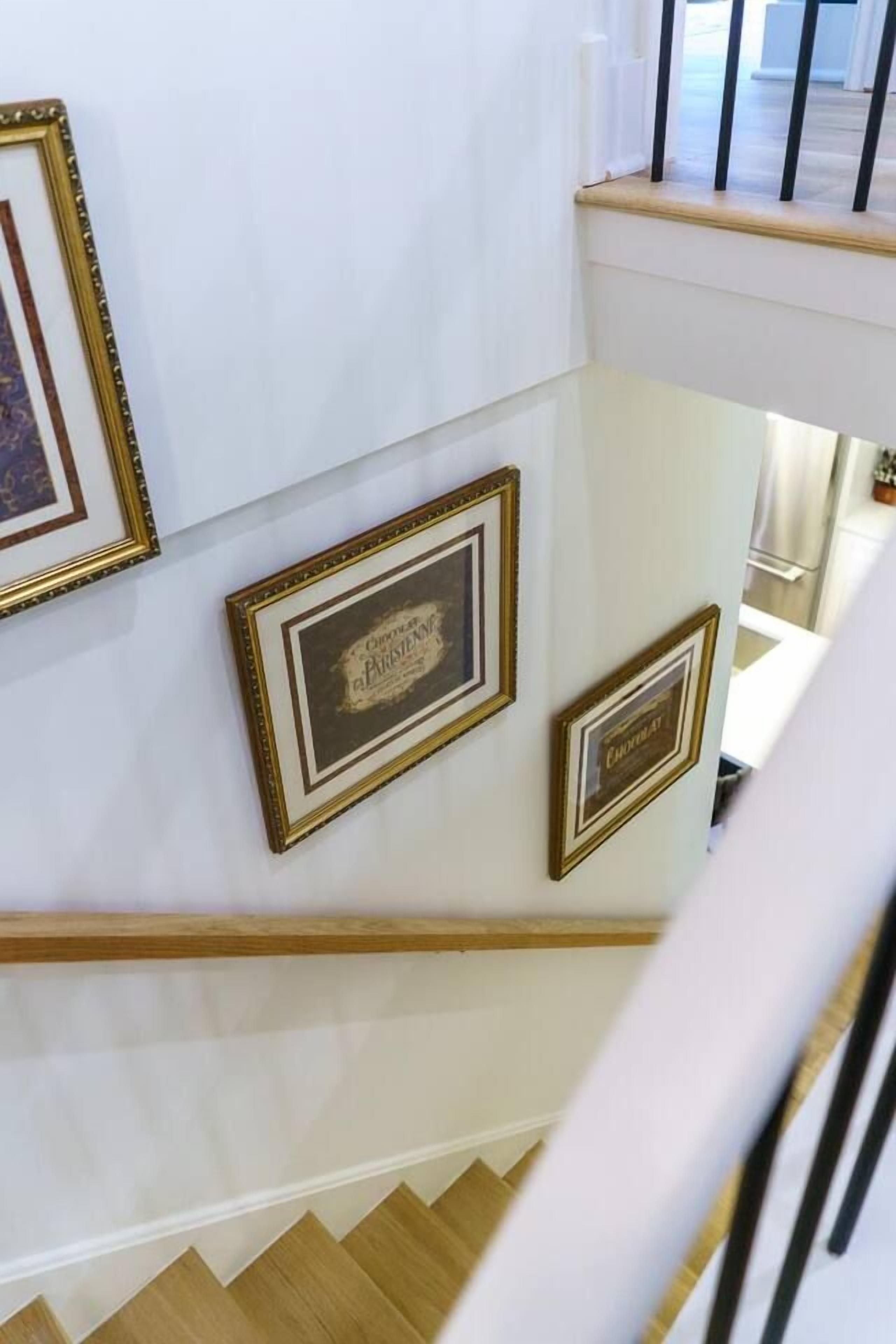 A staircase with wooden steps and white walls.