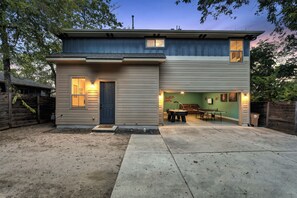 A two-story house with a front door, a small porch, and a pool table in the open area. - Spacious 2 BDRM I Central Austin I Hot Tub (Austin)