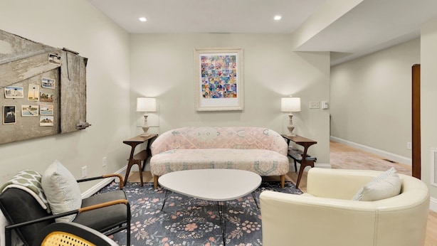 A living room with a sofa, a round coffee table, and a chair. There are two lamps on either side of the sofa. - Sojourn 1 Block to Metro, Cap Hill Garden Flat (Washington)