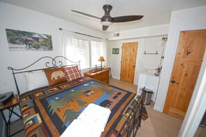 A bedroom with a bed, a ceiling fan, a wooden door, and a window with blinds. - Upgraded Condo with Private Boat Dock - Ski Lease Available (South Lake Tahoe)
