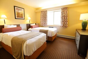 A hotel room with two beds, a dresser, a window with curtains, and a wall-mounted picture. - Enjoy February Break at Pollard Brook! (Lincoln)