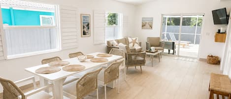 Un vaste espace de vie comprenant une table à manger, des chaises et un canapé.