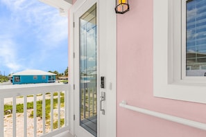 A white door with a glass panel, a metal handle, and a keyhole. - Poolside Fun, Pickleball & Coastal Adventures Await in Fort Myers - Jefferson Palms - Roelens (Fort Myers Beach)