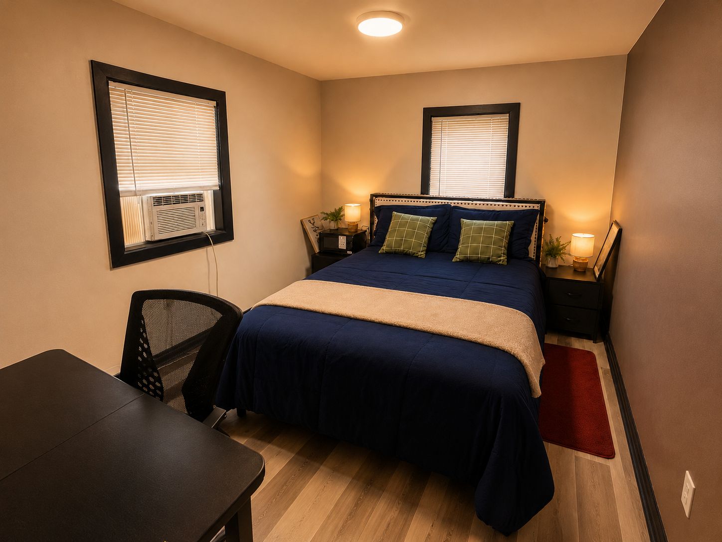 A compact hotel room with a single bed, bedside tables with lamps, a desk, and a chair.
