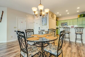 A dining area with a glass table, metal chairs, and a chandelier. - Reserve II- long range views, fireplace, close to ski! (Banner Elk)