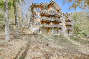 A multi-story building with outdoor balconies, surrounded by trees. - Rotten Dog Getaway: Dog friendly slopeside 2br updated condo on Sugar Mtn! (Sugar Mountain)