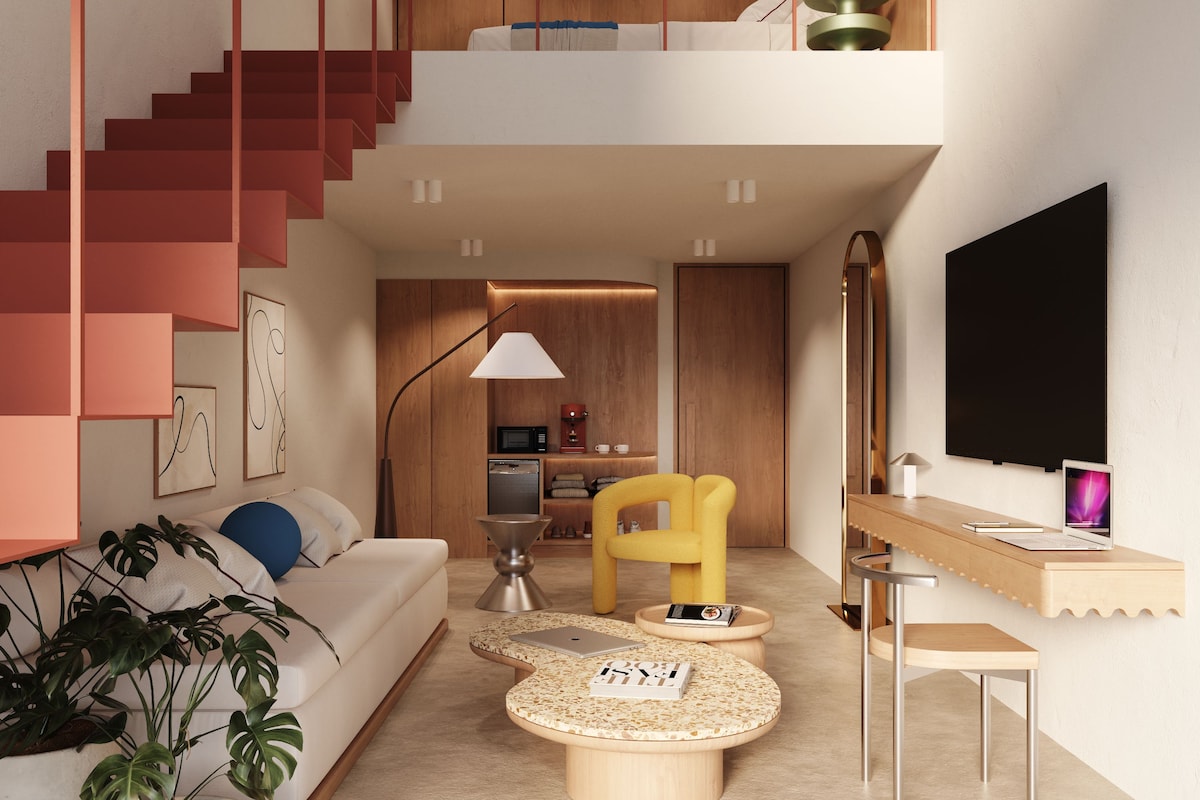 Un interior moderno con una escalera, un sofá, una mesa de centro y un televisor.