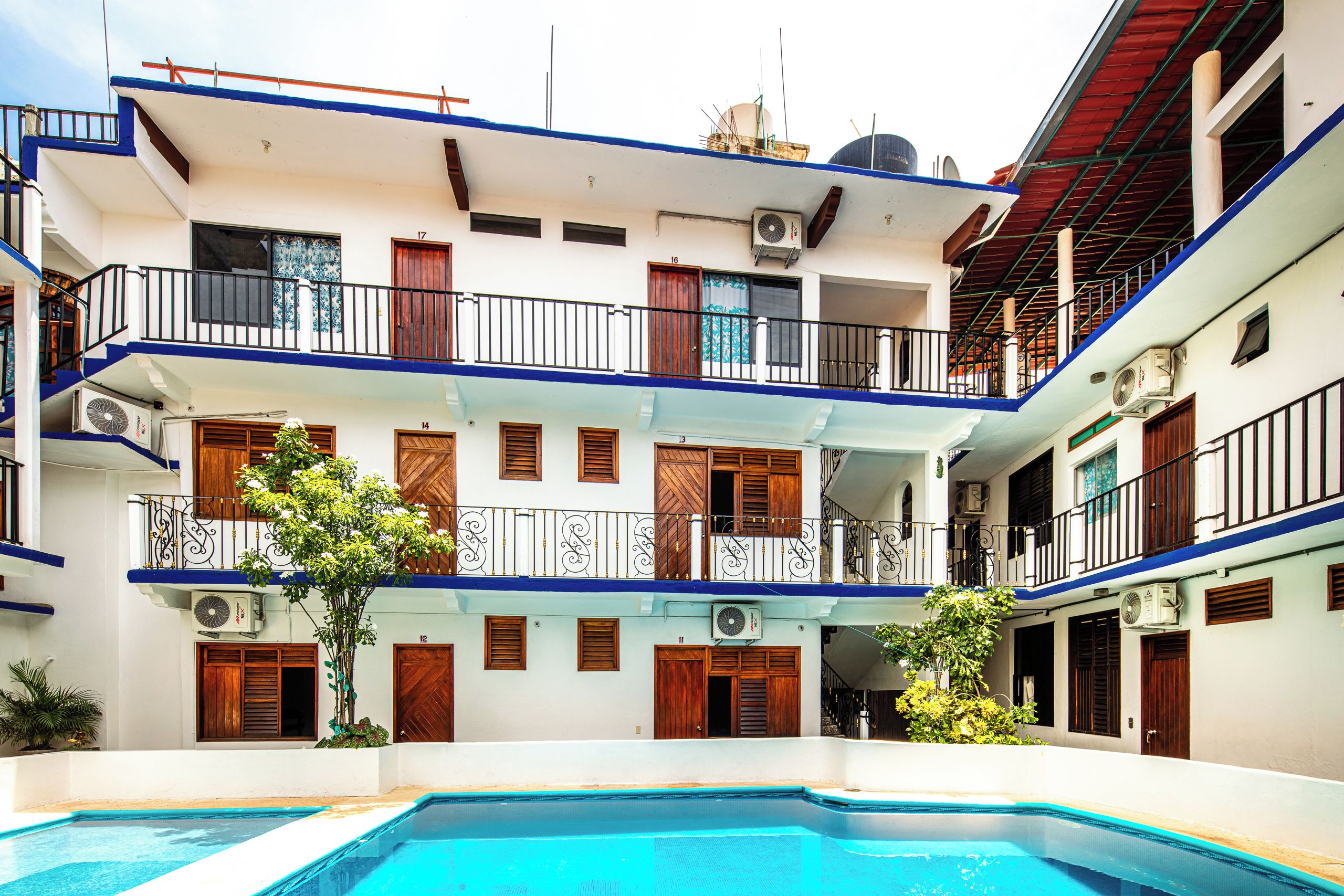 A multi-story building with a swimming pool in the foreground.