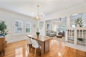 A spacious living area with a dining table, chairs, and a sofa. - NEW LISTING! The Swan on Park: Historic Charm near Lake Hollingsworth & FSC (Lakeland)