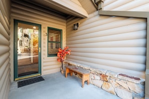 A wooden exterior with a stone wall, a bench, and a door with a window. - Walk to Slopes, Dining & Old Town (Park City)