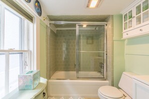 A bathroom with a glass-enclosed shower, a toilet, and a window. - Brackett Cottage: Near Salem! Heart of Historic Marblehead; Walk to Shops & Dining (Marblehead)