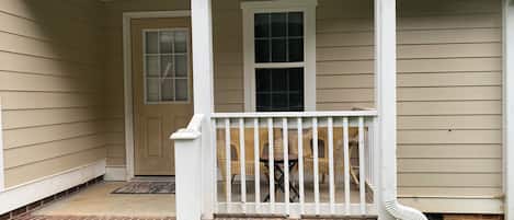 A house with a porch, a door, and a window.