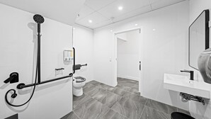 A modern bathroom with a shower, toilet, and sink. - Sleep Different-Stay Inspired-Where inovation meets coastal living-Capsule Hotel (Benowa)