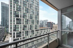 A high-rise building with a balcony overlooking a cityscape. - Lakeview CityPlace 2BR | Free Parking & Balcony | Parking Available (Toronto)