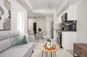 Un appartement moderne comprenant un salon, un coin repas et une cuisine.