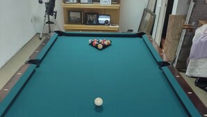A pool table with balls, a telescope, and a shelf with framed photos. - Bed and Breakfast • King Bed + Game Room + Fire Pit (Kiron)