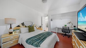 A bedroom with a bed, a desk, a chair, a TV, and a dresser. - Garage, Gated Yard, near SD Gaslamp, DT, 4BR/2Bth (National City)