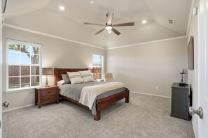 A bedroom with a bed, nightstands, a ceiling fan, and a dresser. - Tranquil Retreat - 3BR/3BA - Centrally Located (Lubbock)