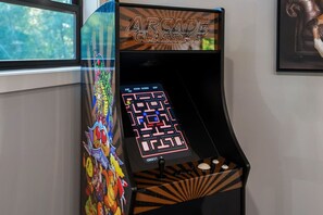 An arcade game machine with a maze game displayed on the screen, labeled 'ARCADE CLASSICS.' - Blackstone Hot Tub • Game Loft (Sevierville)