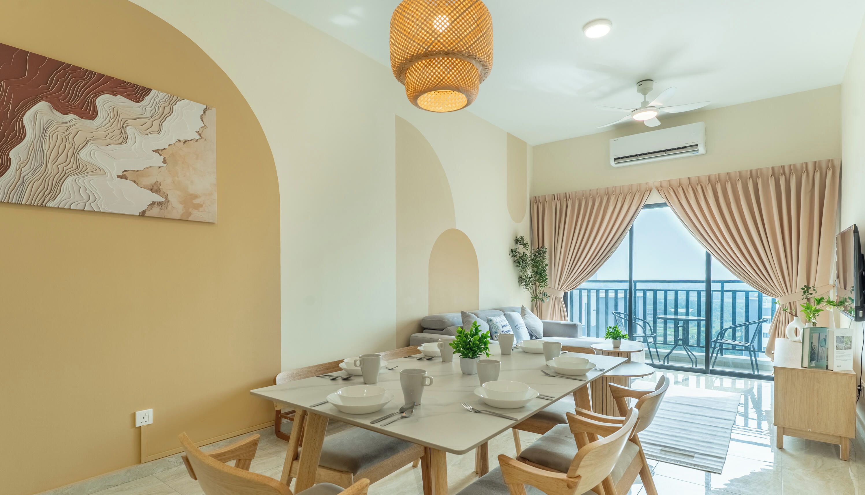 A dining area with a table set for four, a ceiling fan, and a large window with curtains.
