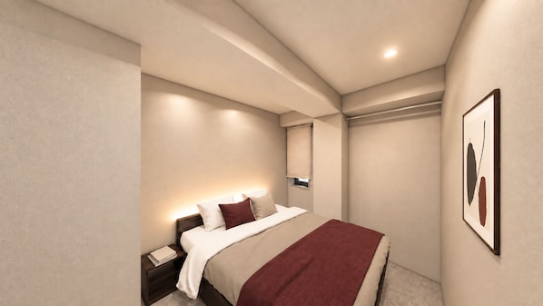 A modern hotel room with a bed, bedside table, and a framed picture on the wall.