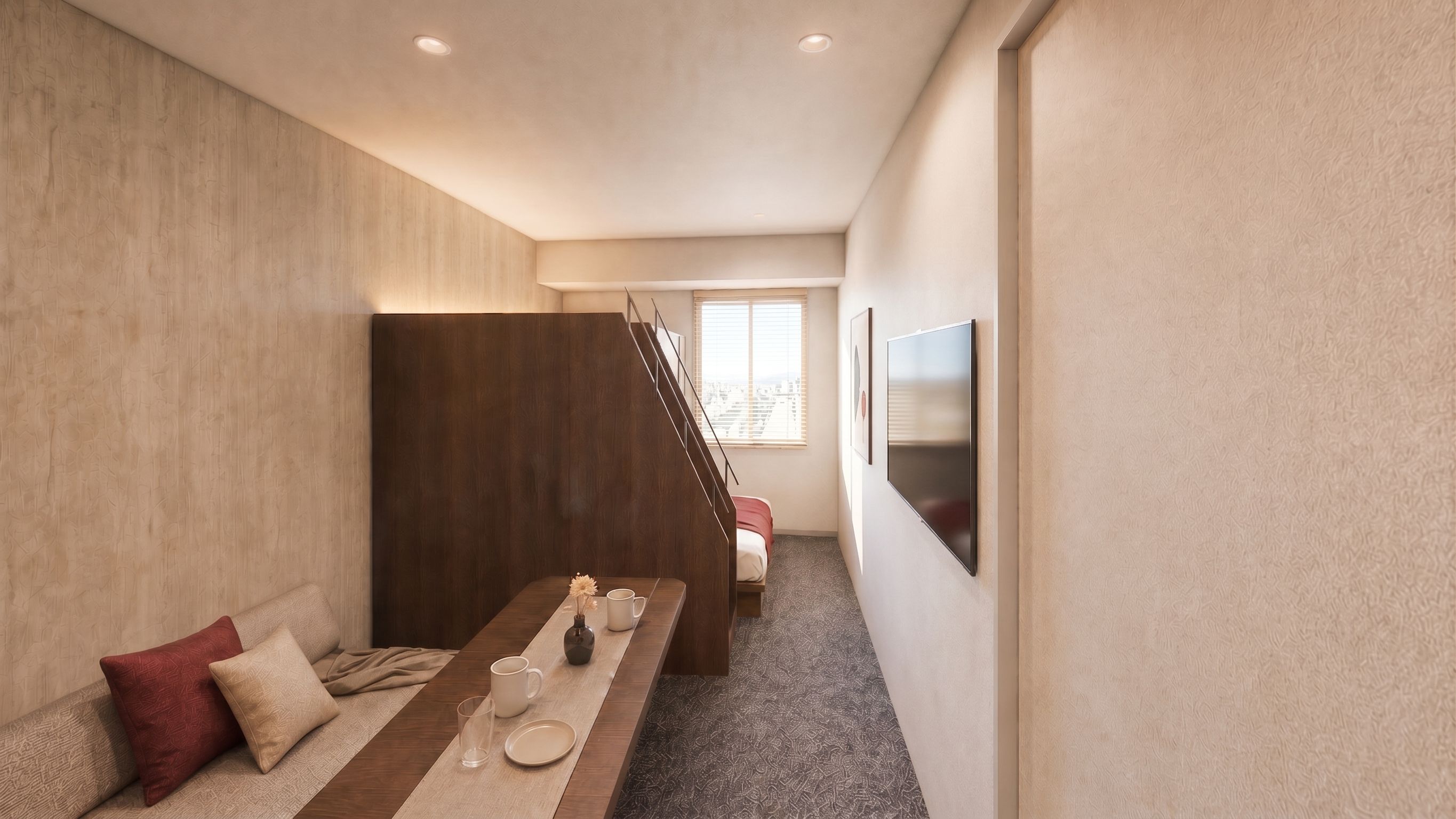 A modern hotel room with a sofa, a dining table with a vase and cups, a staircase, and a TV mounted on the wall.
