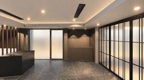 A reception area with a reception desk, a seating area, and a wall with a grid pattern.