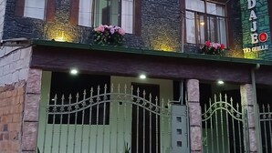 A two-story building with a sign reading 'HOSPEDAL' and 'TO GUILLE'. - An Airbnb-style vacation rental, perfect if you're visiting Podocarpus Park. (Zamora)