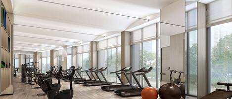 Un gimnasio moderno con cintas de correr, bicicletas estáticas y pelotas de ejercicio.