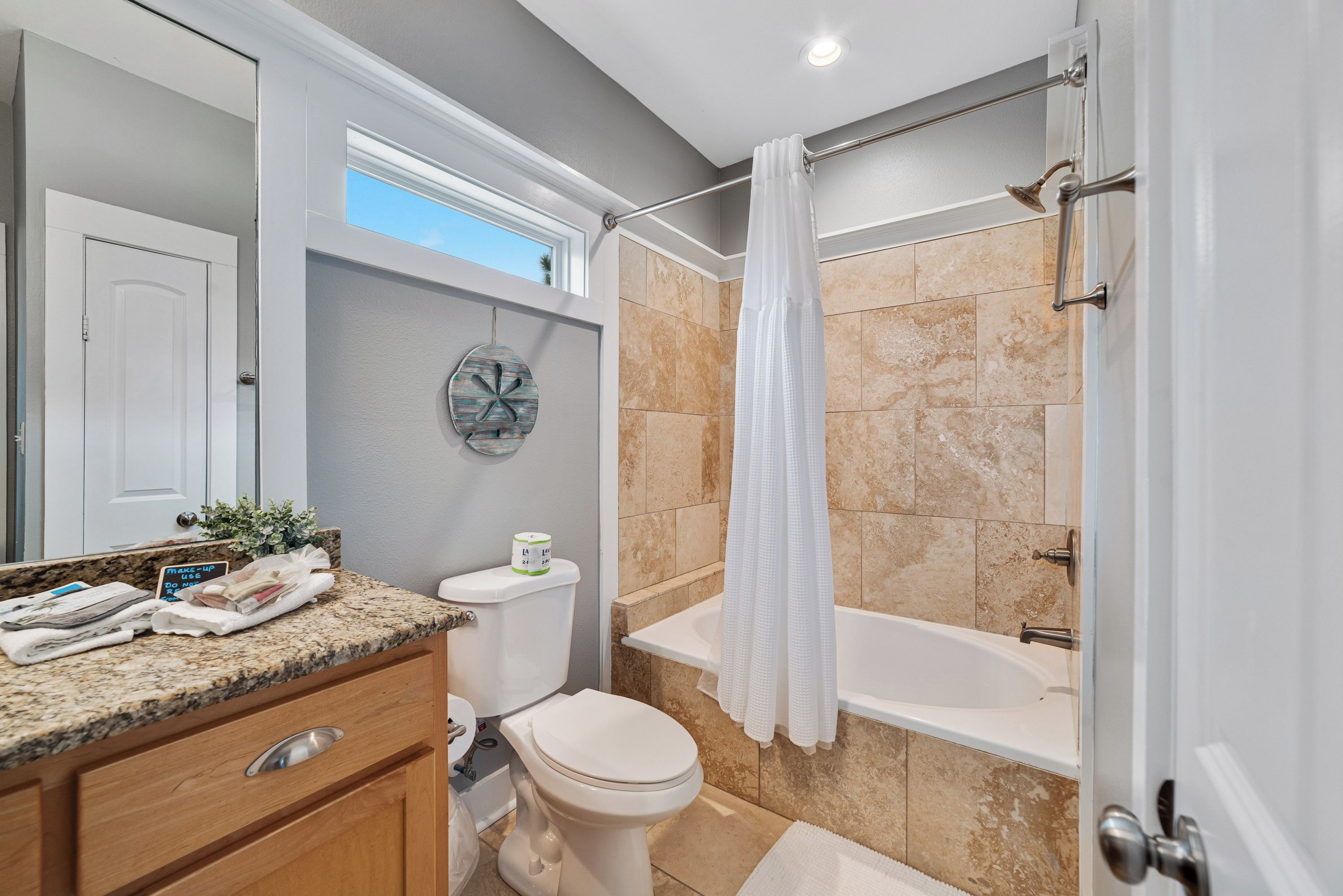 A bathroom with a toilet, sink, and bathtub.