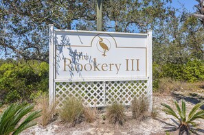 A sign for The Rookery III with a bird logo. - 5003 Rookery 3 The Sea Pearl (Gulf Shores)