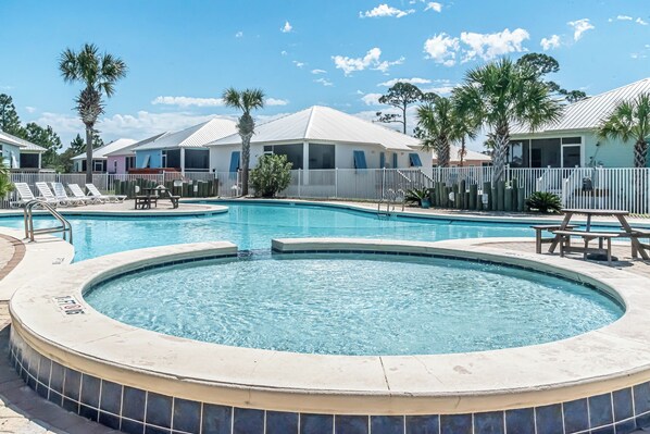 A swimming pool with a hot tub, lounge chairs, and a fenced area with palm trees. - 5003 Rookery 3 The Sea Pearl (Gulf Shores)