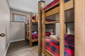 A bunk bed room with a window and a door. - Big White is Calling - Full House with Hot Tub (Kootenay Boundary)