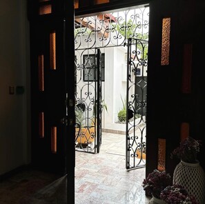 A doorway with a wrought iron gate leading to an outdoor area with potted plants. - spacious 5-bedroom house in peaceful Oaxaca de Juárez, Graden (Oaxaca de Juárez)