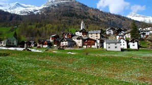 A village with traditional wooden houses, a church, and a mountain backdrop. - Il Nido Di Gurin 2 -Ski hike and trail Bosco Gurin, Bosco Gurin, Switzerland (Bosco Gurin)