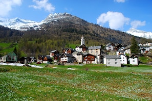 A village with traditional wooden houses, a church, and a mountain backdrop. - Il Nido Di Gurin 2 -Ski hike and trail Bosco Gurin, Bosco Gurin, Switzerland (Bosco Gurin)