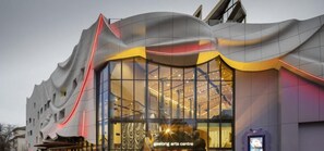 A modern building with a unique wavy facade and a glass entrance. - Devlin 103 - Stylish Geelong Apartment (Greater Geelong)