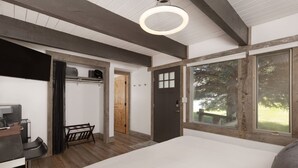 Quarto com uma cama grande, uma escrivaninha com computador, uma cadeira e janela com vista para árvores.