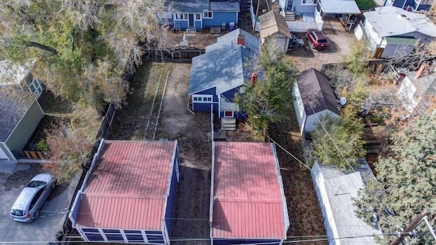 A residential area with two detached houses, one with a red roof and another with a grey roof, surrounded by trees and a parked car. - City Center Cottage Netflix, Mtns & Adventure! (Colorado Springs)