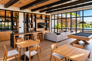 A modern interior with a pool table, sofa, and dining area. - Chic Versalles Condo • Infinity Pool, Coworking (Puerto Vallarta)