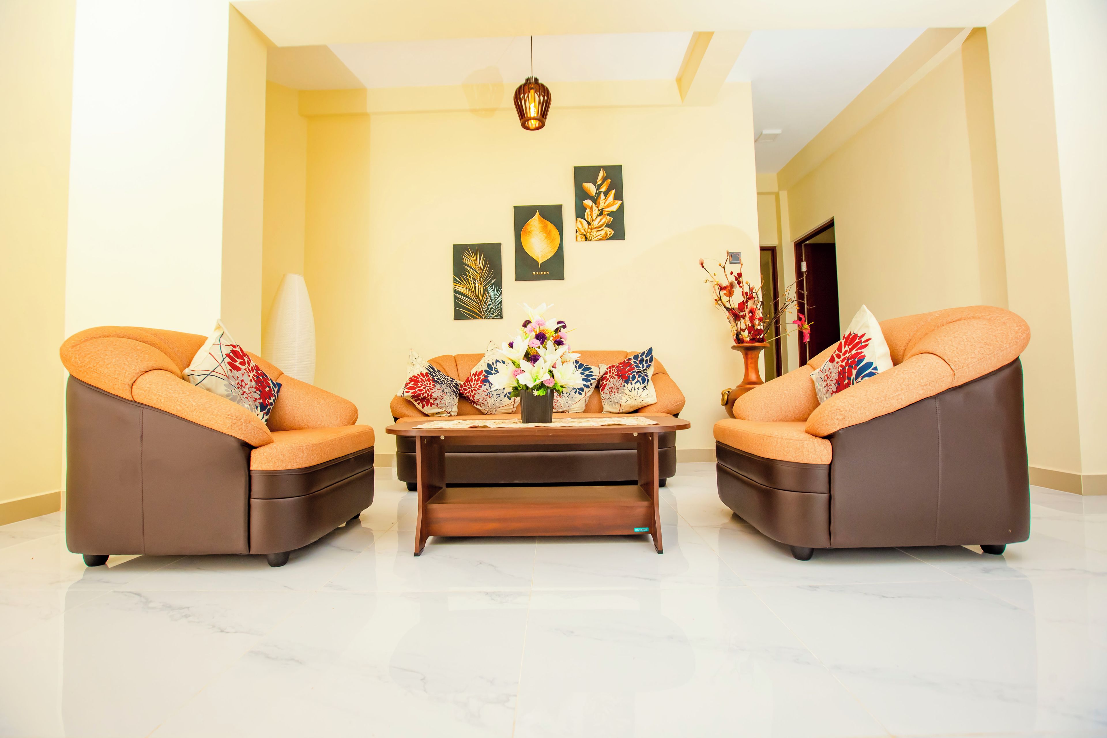 A living room with two sofas, a coffee table, and wall art.