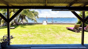 Un espacio al aire libre techado con vista a una playa y al mar.