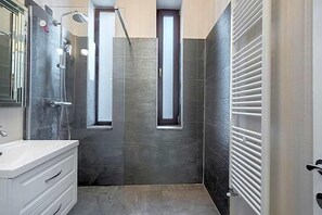 A modern bathroom with a shower, a sink, and a window. - Highline Downtown Old Town Unirii Square (Bucharest)