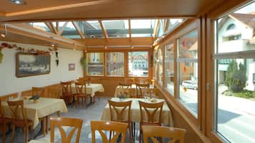 A restaurant with wooden interior and large windows.